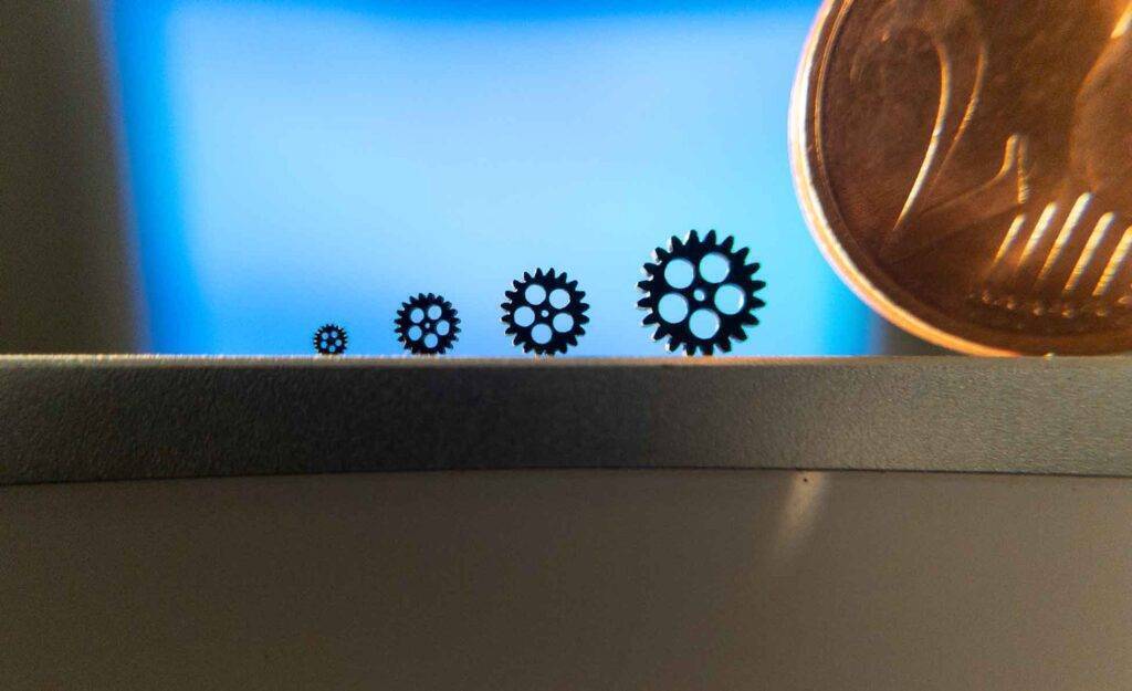 Gears created using 3D printing for micro molding. Euro shown for comparison.